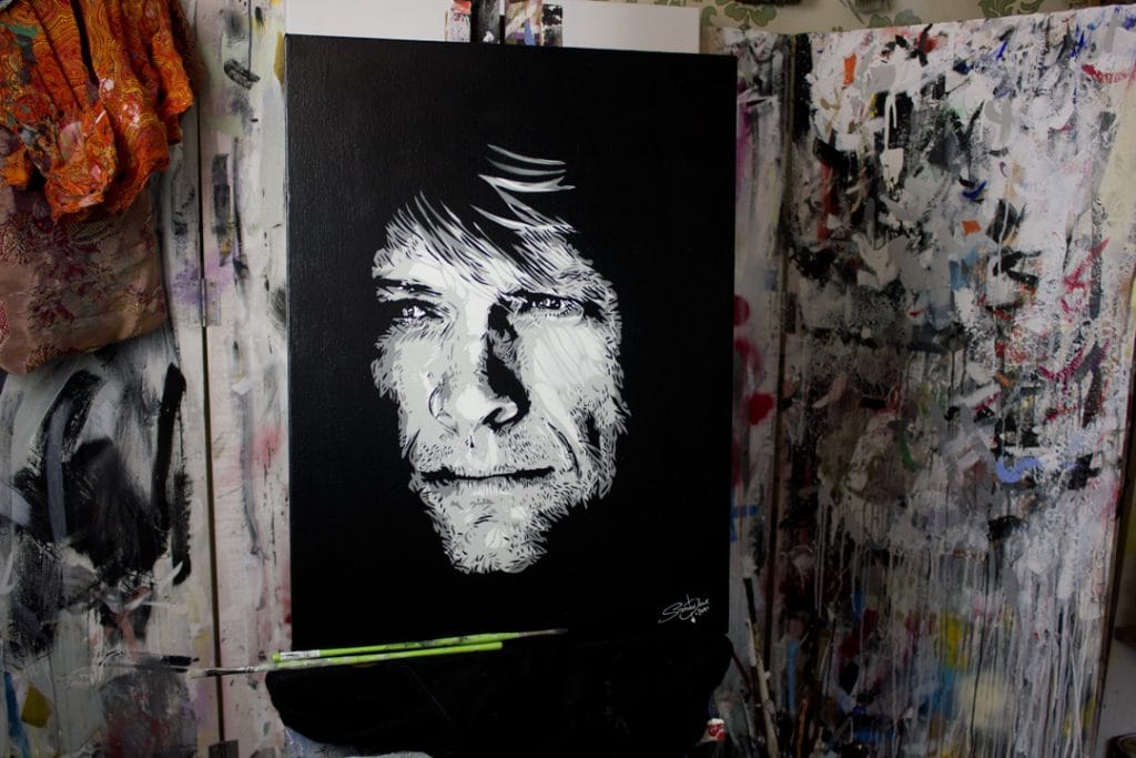 jon bon jovi painting on a easel
