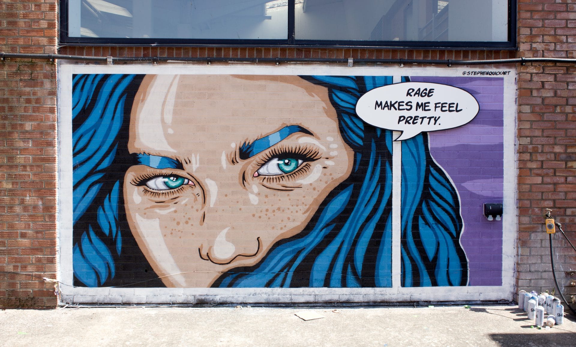 Stephen Quick painting the "Rage Makes Me Feel Pretty" mural at Upfest 2026 in Bristol