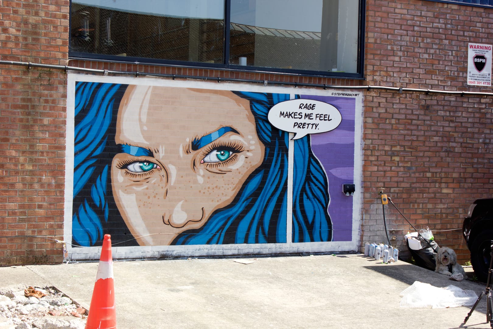 Stephen Quick painting the "Rage Makes Me Feel Pretty" mural at Upfest 2026 in Bristol