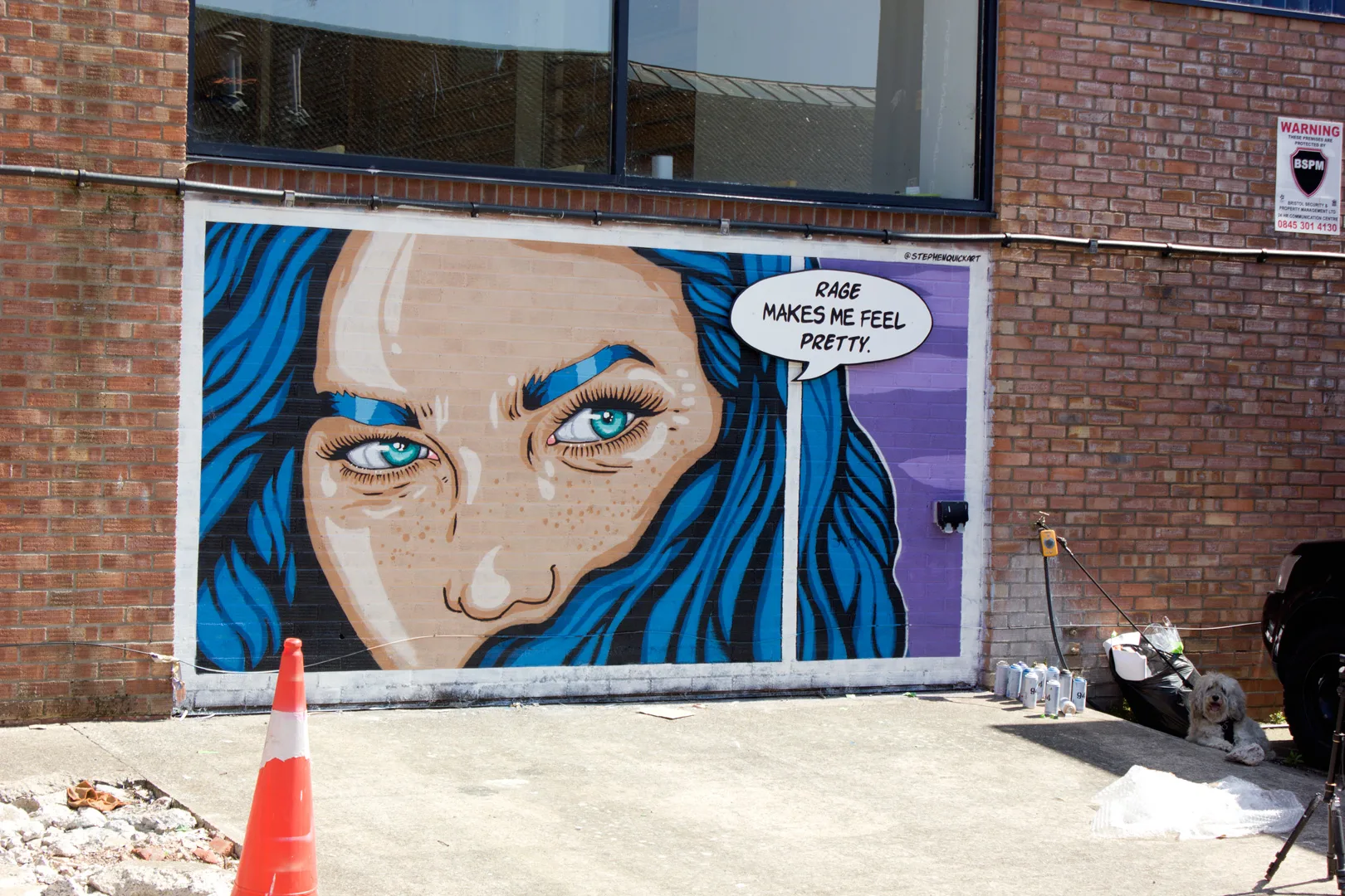 Stephen Quick painting the "Rage Makes Me Feel Pretty" mural at Upfest 2026 in Bristol